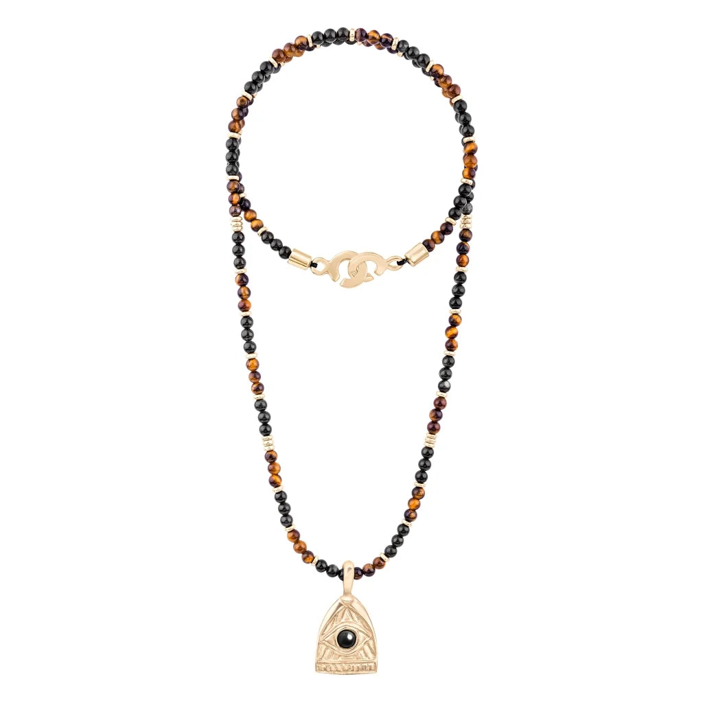 Collar de 39cm con piedras de 4mm, mini donas en acero, dije de ojo terminado en acero anticado bañado en oro 22K - Joyería y bisutería fina
