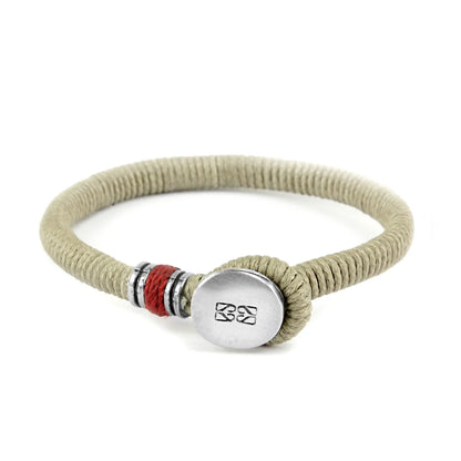 Pulsera unisex con hilo encerado, complementada con un cilindro y un broche de botón en terminado acero. Disponible en 6 colores de hilo. - Joyería y bisutería fina