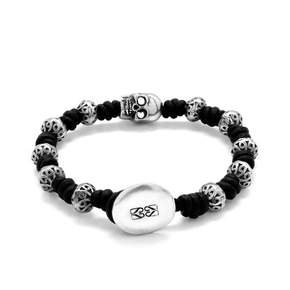 Pulsera de nudos de piel natural española, con broche de botón, mantras y calavera en terminado de acero - Joyería y bisutería fina
